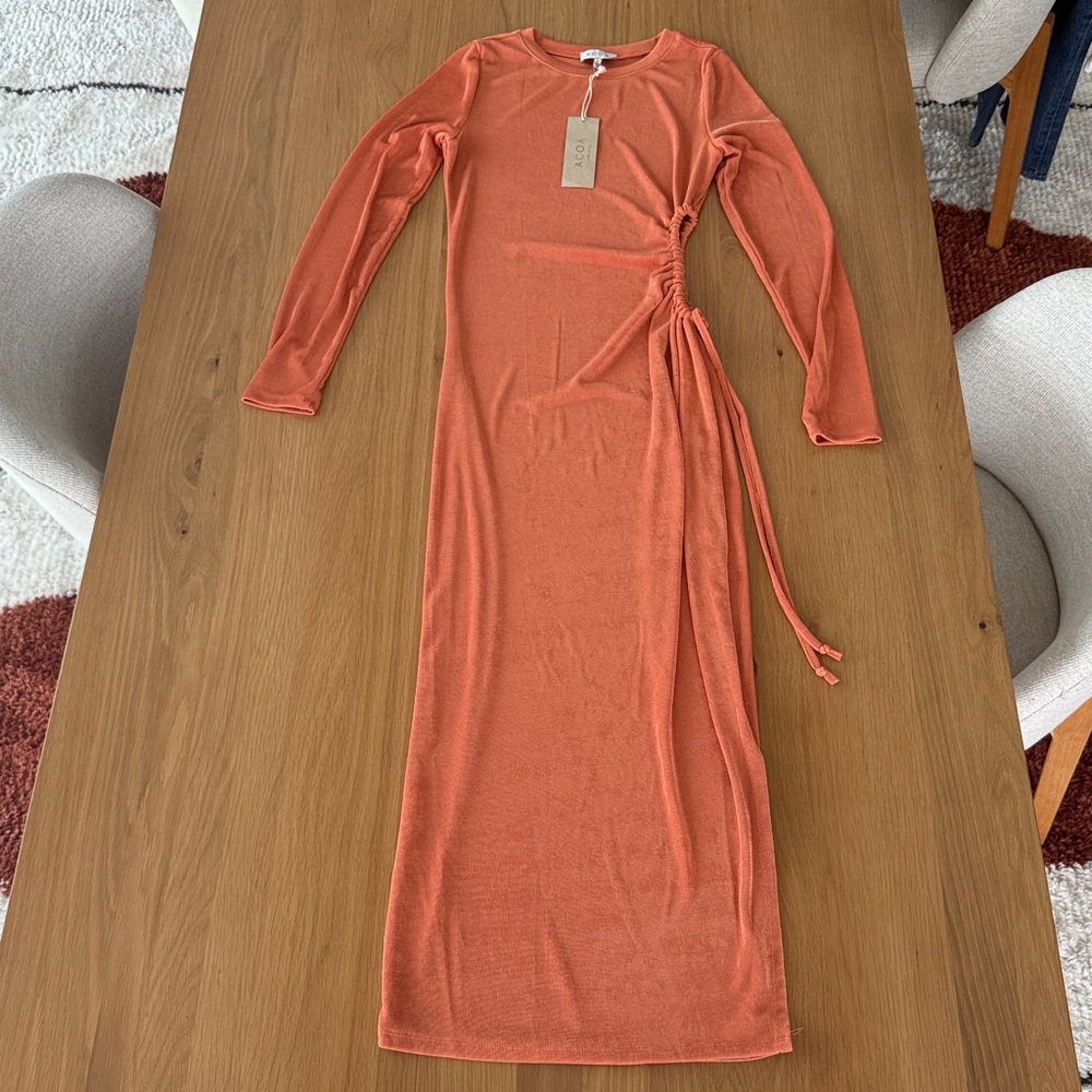 Long sleeved orange dress with side cut out. Stretchy material. Size M. Acoa